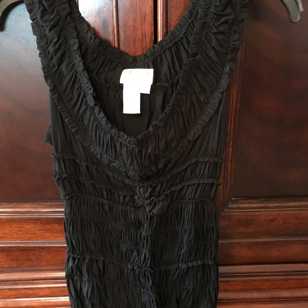 Sleeveless black top with ruffles